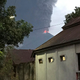 Plumes of volcanic ash rise from Mount Soputan.